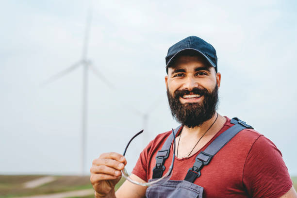 istock Young maintenance engineer man working in wind turbine farm 1270402063