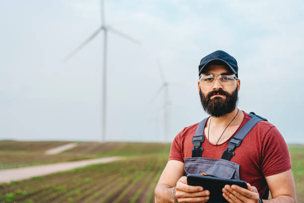 istock Young maintenance engineer man working in wind turbine farm 1270402261
