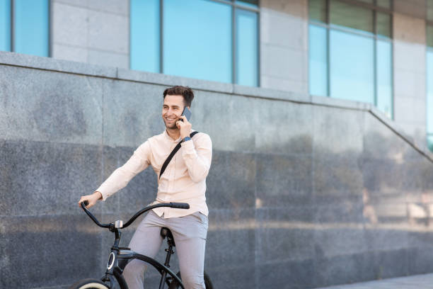 istock Communication on smartphone during ride. Young businessman with bicycle 1270403285