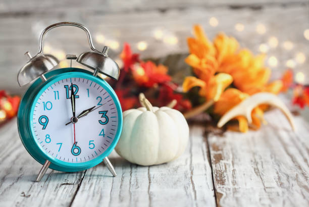 daylight savings time with clock and white pumpkin - time and space imagens e fotografias de stock