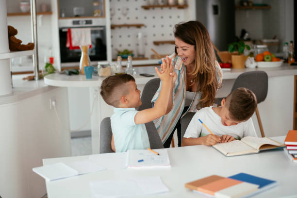 istock Mother helping her son with homework at home. 1270405472