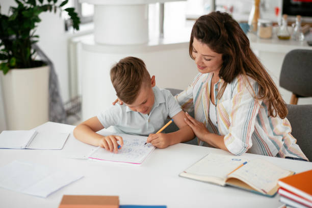 istock Mother helping her son with homework at home. 1270405647