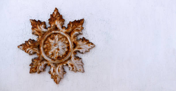 Rusty star on an old white house wall