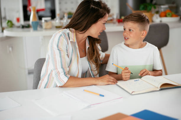 istock Mother helping her son with homework at home. 1270405740