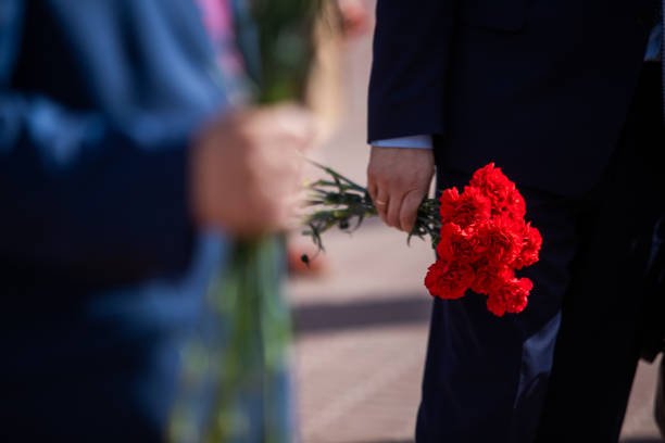 istock Holds red carnations, a memorable day of mourning. 1270407683