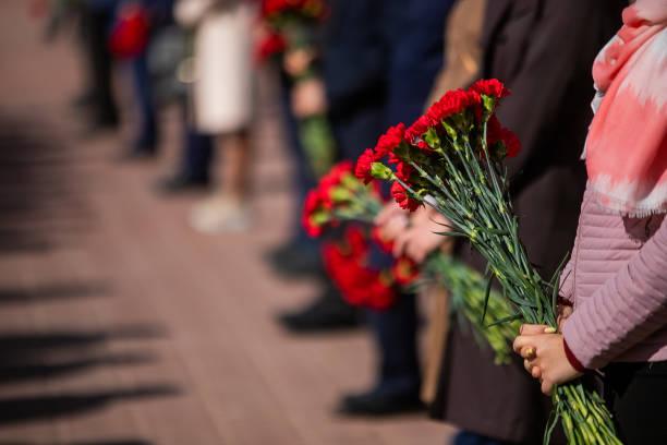 istock Holds red carnations, a memorable day of mourning. 1270407718