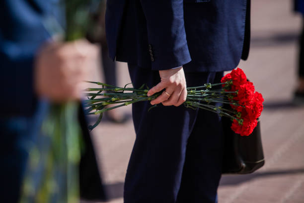 istock Holds red carnations, a memorable day of mourning. 1270408299
