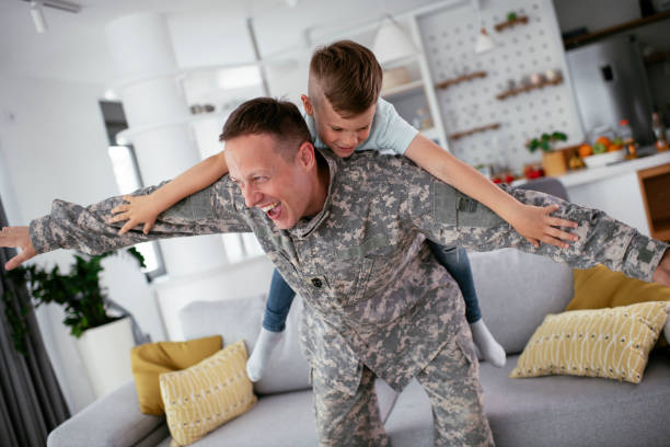 istock Soldier having fun with his son at home 1270409859