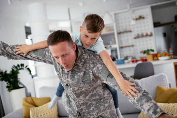 istock Soldier having fun with his son at home 1270409866