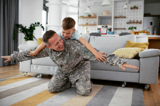 istock Soldier having fun with his son at home 1270409940