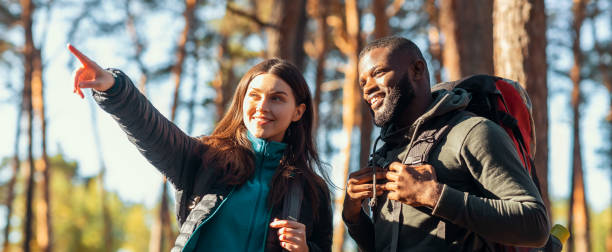 istock Panoramic photo of two backpackers enjoying forest views 1270409974