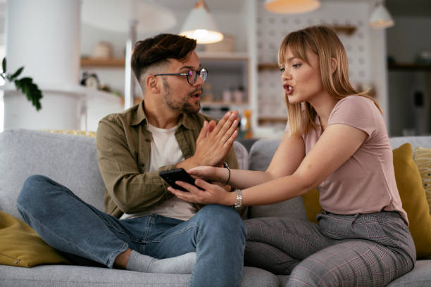 Boyfriend and girlfriend are arguing on the couch. stock photo