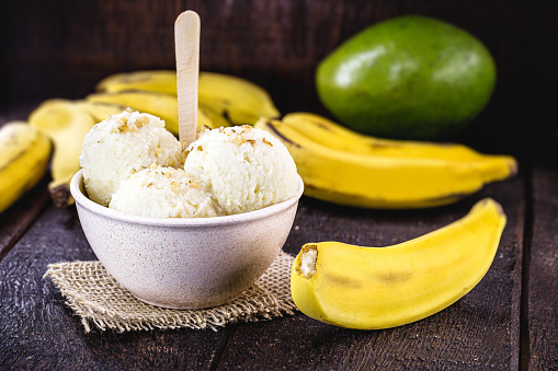 natural banana ice cream without preservatives. Gourmet iced dessert, of organic fruit, in recycled plastic pot