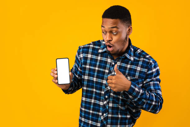 istock African Man Showing Smartphone Screen Gesturing Thumbs-Up, Studio Shot, Mockup 1270411217
