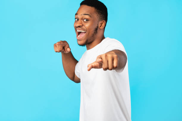 istock Black Man Pointing Fingers At Camera Over Blue Studio Background 1270411242