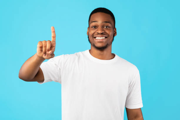 istock Smiling Black Guy Showing Number One With Finger, Studio Shot 1270411288