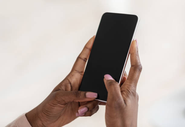istock Modern Smartphone With Black Blank Screen In Hands Of Unrecognizable Black Lady 1270411461
