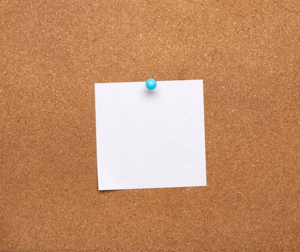 istock blank square white sheet of paper attached with blue button on a brown background 1270411585