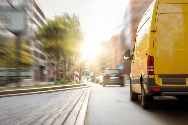 istock Delivery van driving in the city 1270412712