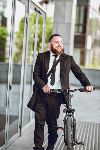 istock Businessman Pushing Bicycle Into Office Holding After Riding It To Work 1270412852