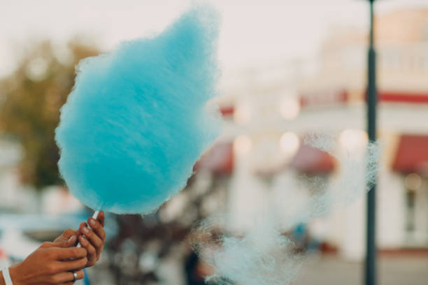 Cotton Candy floss machine making blue candyfloss outdoor Cotton Candy floss machine making blue candyfloss outdoor. candyfloss stock pictures, royalty-free photos & images