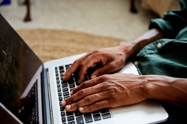 istock Young man using a laptop on his living room floor at home 1270414498