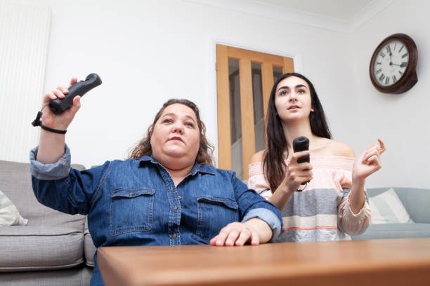 istock Family having fun playing a video game at home viewed from a low angle 1270414585