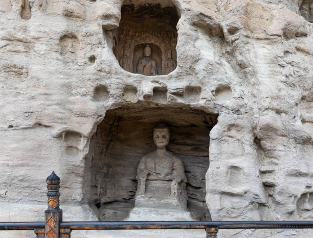 Weathered Buddha statue in a niche at Yungang Grottoes