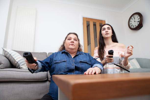 istock Family having fun playing a video game at home viewed from a low angle 1270415175