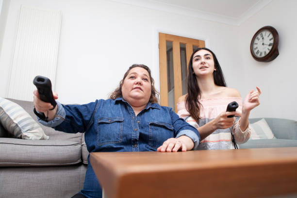 istock Family having fun playing a video game at home viewed from a low angle 1270415176