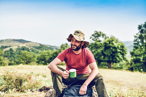 Hispanic Male Taking A Tea Break During Hiking