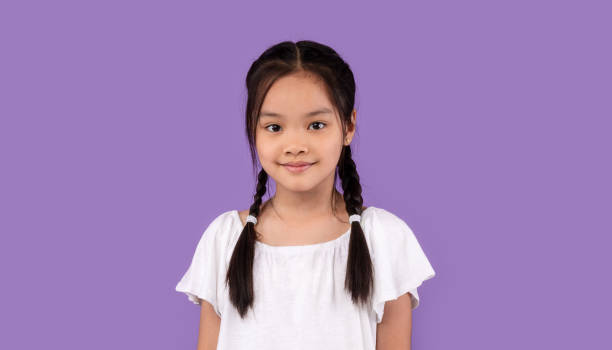 istock Cute Asian Kid Girl Posing Standing Over Purple Background, Studio 1270415769