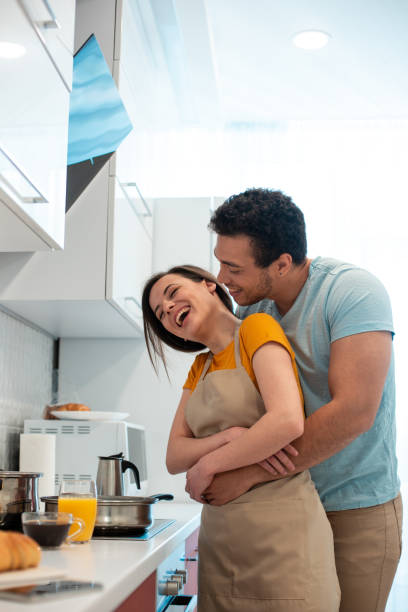 istock Delighted lady laughing and boyfriend hugging her 1270415827