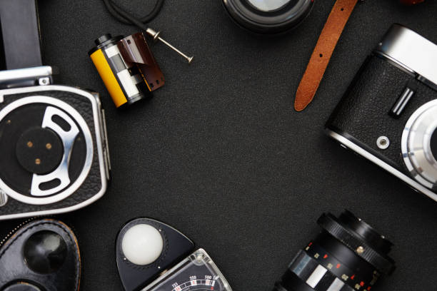 istock Top view photography equipment on black table background. Flat lay items making a frame with copy space 1270416811
