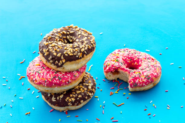 istock Colorful donuts close up, glazed and sprinkles bakery 1270418823