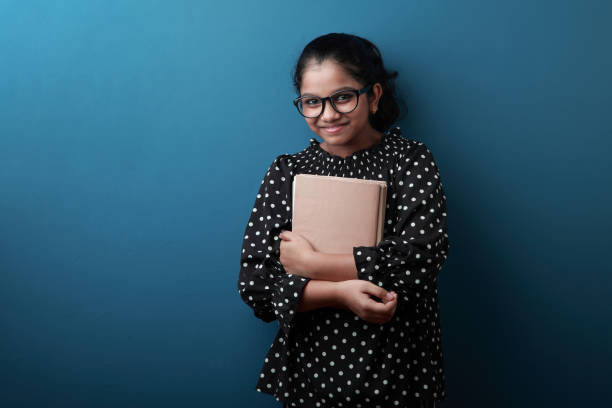 istock Happy young girl holding note books in her hand 1270419906