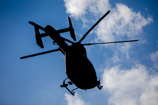 Richmond, Canada - 15th September 2023: C-CHJT, a Sikorsky S-76A helicopter operated by Helijet International with the branding of their charity Helicopters Without Borders, flying against a clear, blue sky. Vancouver South Airport, Richmond, BC,. Canada.