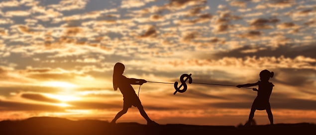 Silhouette of two girl pulling rope dollar at sunset background.