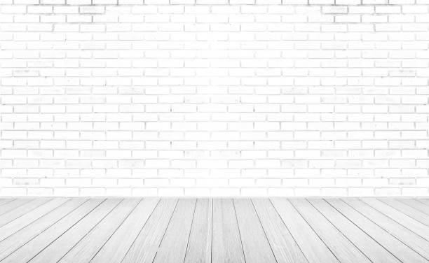 istock Empty room with grey wooden floor with brick wall background. Studio or office blank space. 1270424406