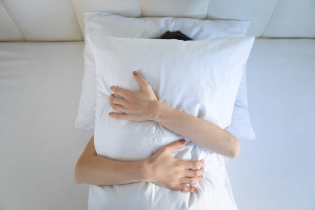 istock Women in bed hugging the pillow 1270425756