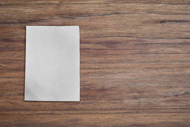 istock White paper pad on wood desk background with copy space. Top down 1270426838