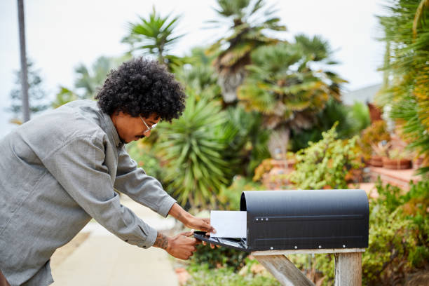 istock Young man standing outside and checking for mail 1270429626