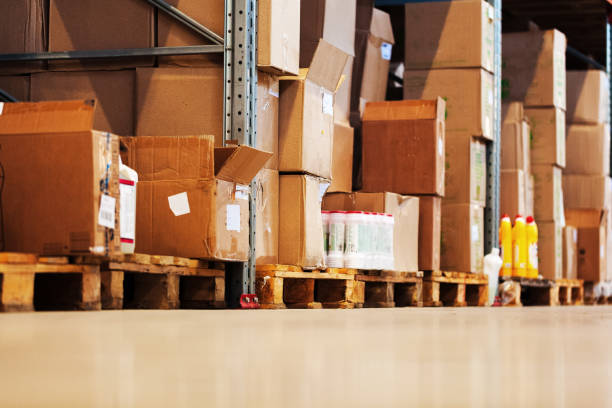 istock Modern warehouse shelves with pile of cardboard boxes 1270430772