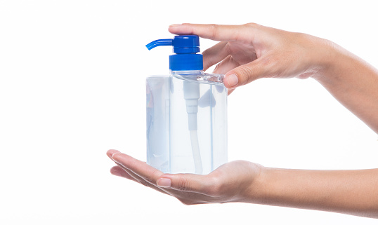 New Normal People industry Lifestyle after Covid-19 Concept, woman 2 hands held Sanitizer dispenser Alcohol 70% Gel pump bottle to wash and protect Coronavirus from carrier, isolated white background