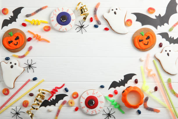 istock Halloween background with gingerbread and other sweets top view with place for text 1270433987