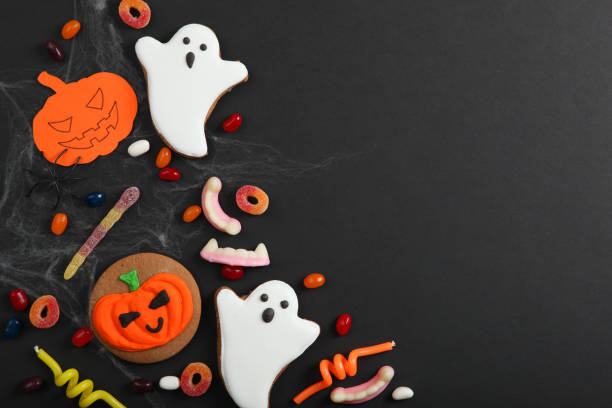 istock Halloween background with gingerbread and other sweets top view with place for text 1270434023