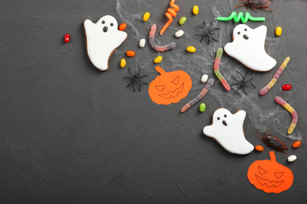 istock Halloween background with gingerbread and other sweets top view with place for text 1270434179