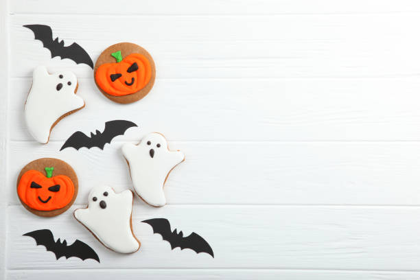 istock Halloween background with gingerbread and other sweets top view with place for text 1270434402
