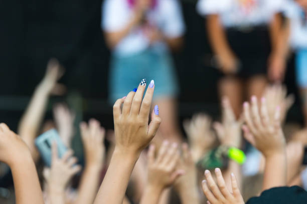 istock Crowd With Arms Raised In Concert 1270434495