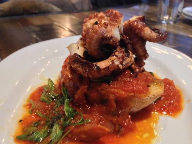 istock Olive Oil Grilled Octopus And Tomato Sauce Crostini 1270435999
